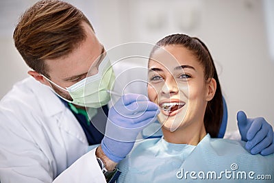 Dentist checking up femaleâ€™s teeth Stock Photo